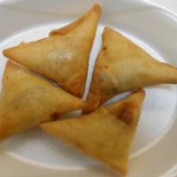 Chicken Samosa (4 Pcs) · A fried triangular savory pastry containing chicken, herb, and spices. Served with green chu...