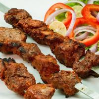 Beef Boti Kabab With Rice · Boneless beef cubes marinated in yogurt, herb, and spices. Skewer on open fire. Served with ...