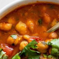 Chana Masala · Chick peas cooked in spicy curry sauce. Served with your choice of 2 tandoori naans or 1 bas...