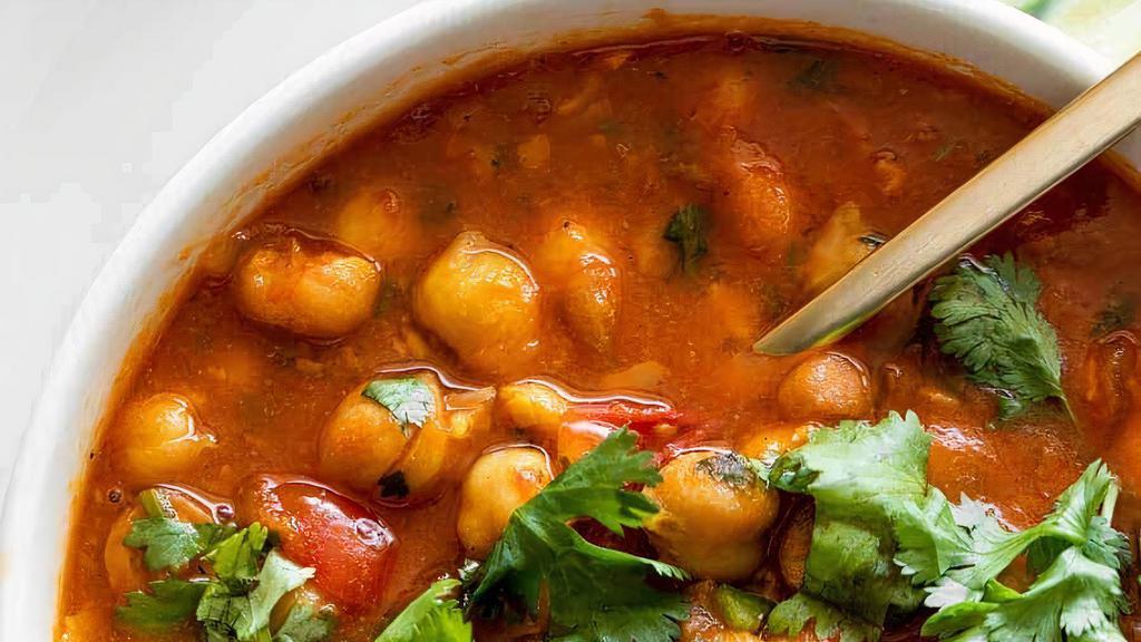Chana Masala · Chick peas cooked in spicy curry sauce. Served with your choice of 2 tandoori naans or 1 basmati rice.