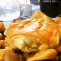 Killian Special · Home fries with sautéed onions & peppers covered with cheese, topped with two eggs & toast o...
