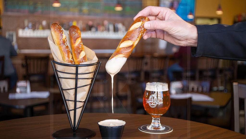 Pretzels & Beer Cheese · Soft, warm Bavarian pretzel sticks brushed with butter and sprinkled with sea salt. Served with house-made beer cheese.
