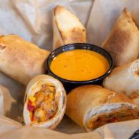 Southwest Egg Rolls · Hot and spicy egg rolls with chicken, cheese, black beans, corn and jalapeños - served with ...