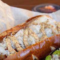 The German · 1/4 lb brat marinated in craft beer, served in a toasted pretzel bun with whole grain mustar...