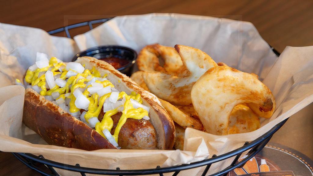 The Wisconsin · 1/4 brat marinated in craft beer in a toasted pretzel bun. Topped with raw onion and your choice of ketchup, yellow or spicy grain mustard.