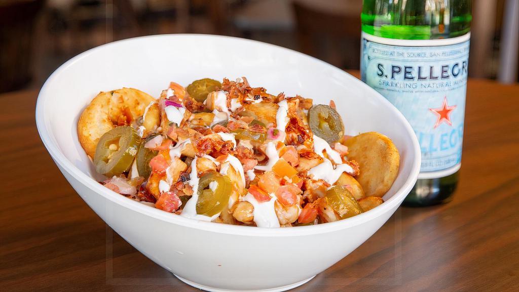 Loaded Sidewinders · Crispy beer-battered potatoes with our housemade beer cheese with BBQ chicken topped with sour cream, bacon, jalapeños and pico de gallo.