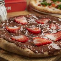 Chocolate Pizza · Small pizza with Nutella spread, strawberries and powdered sugar.