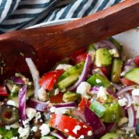 Greek Salad · Fresh tomato, feta cheese, cucumbers, onions, oregano, peppers and virgin olive oil.