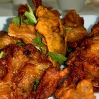Vegetable Pakora · Crispy light fritters made of potato, onions, and spinach dipped in a split gram batter and ...