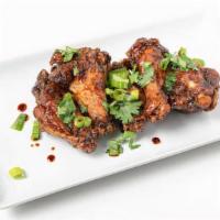 Szechuan Chicken Wings · Five crispy wings tossed in a sticky, spicy, sweet sauce and topped with fresh spring onion ...
