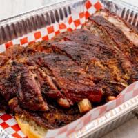 Half Slab Of Ribs · Half Slab Ribs are pre-seasoned with our secret house blend of spices. Grilled over an open ...