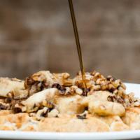 Belgian Waffle · Buttermilk waffle with bananas, walnuts and butter with a side of maple syrup.