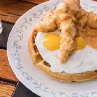 Chicken And Waffle · malted waffle, crispy chicken tenders, sunny up local eggs, maple syrup, house country gravy