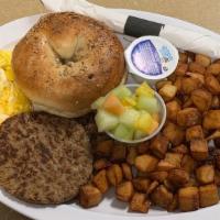 Breakfast Platter · Two eggs, choice of bacon or sausage, toast, breakfast potatoes, and a fruit garnish.