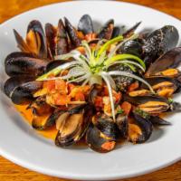 Cozze Al Aglio · Mussels cooked in white wine, garlic, and clam juice. Finished with parsley and olive oil.