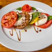Heirloom Caprese · Fresh mozzarella cheese, heirloom tomatoes, and sweet peppers. Finished with our homemade ba...