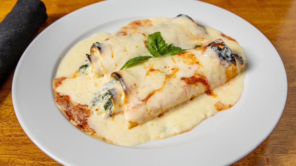 Cannelloni Di Spinaci · A pasta sheet, filled with spinach, Parmigiano-Reggiano, and ricotta cheese. Served in a bechamel sauce.