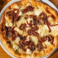 Caprino E Fichi Pizza · Roasted figs, caramelized onions, garlic, olive oil, and goat cheese.