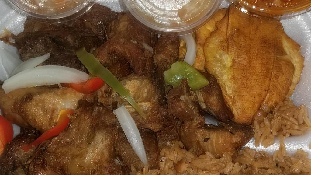 Griot · Served with plantains, and rice.
