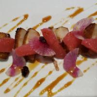Bacon Steakie · Marinated pork belly cooked with sous vide garnished with serano chili watermelon, radish, g...