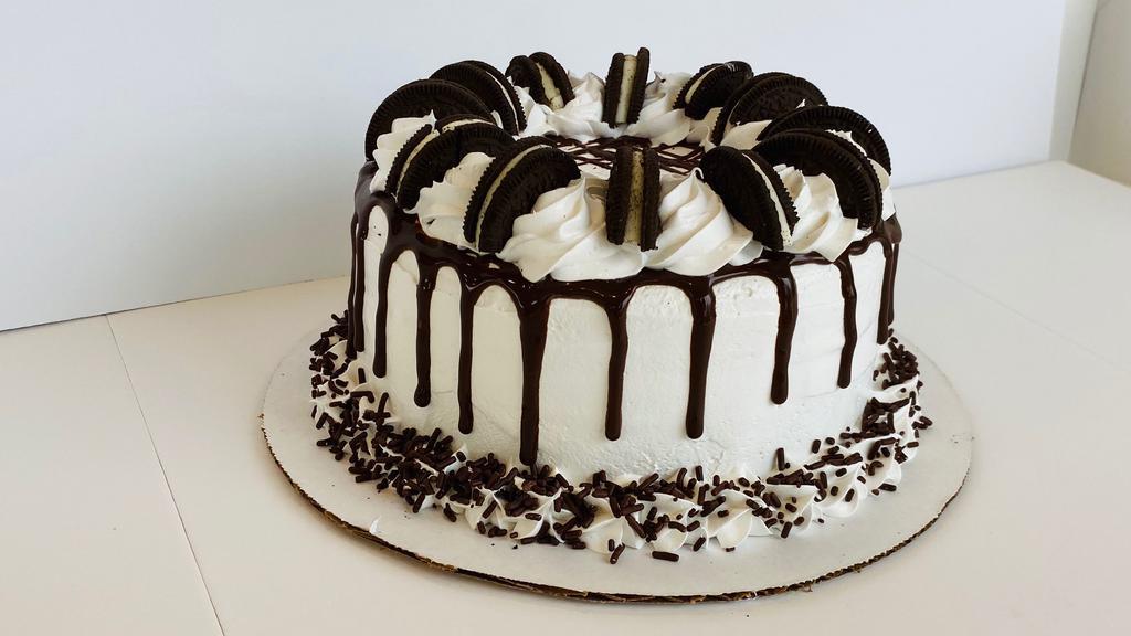Mookie'S Cookies 'N' Cream Cake · 7-inch round cake, serves 10-12. Delicious cookies ‘n’ cream & vanilla froyo layers on a white/vanilla cake base, with a luscious filling of fudge sauce & Oreos, and even more on top! Please call the store at 469-454-6797 to confirm availability BEFORE ordering.