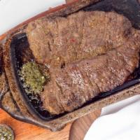 Carne Asada · Grilled sirloin steak. Served with grilled onios, charros, rice, guacamole, pico de gallo an...