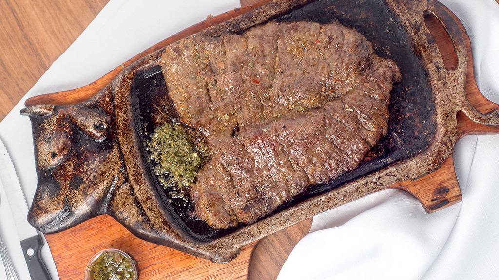 Carne Asada · Grilled sirloin steak. Served with grilled onios, charros, rice, guacamole, pico de gallo and tortillas.