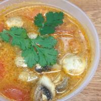 Spicy Shrimp Soup · Tom Yam Kung. Hot and spicy. Shrimp and mushroom with tomatoes and Tom-Yum soup.