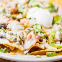 Loaded Nachos · Tortilla chips loaded with your choice of chicken or beef, queso, sour cream, pico de gallo ...