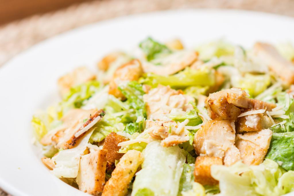 Chicken Caesar Salad · Crisp romaine lettuce with shredded parmesan cheese, grilled chicken, and croutons. Served with caesar dressing.