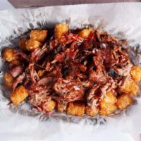 Bbq Tater Tots · A bed of tater tots topped with melted cheese, our smoked pulled pork, sweet sauce and dry r...