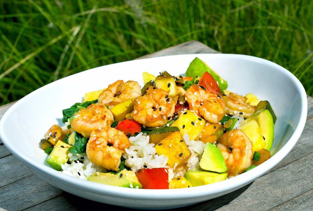 Hawaiian Shrimp Bowl · Fresh shrimp, squash, zucchini, peppers and pineapple, sautéed in a ginger-soy glaze. Served over sticky rice and spinach. Finished with diced avocados, green onions and sesame seeds.