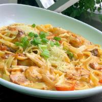 Shrimp & Scallops Pasta · Sautéed shrimp and scallops tossed in a creamy sun-dried tomato sauce topped with Parmesan a...