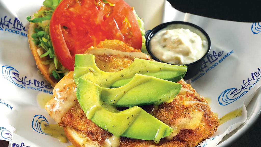Boca Style Grouper Sandwich · Breaded and pan-sautéed grouper topped with fresh avocado, tomatoes and lettuce. Finished with a key lime drizzle.