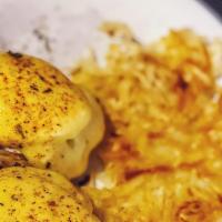 Eggs Benedict · Two poached eggs and Canadian bacon on a toasted English muffin, topped with hollandaise sau...