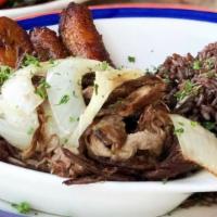 Lechon Asado · Pulled oven roasted pork grilled with onions and garlic mojo sauce.