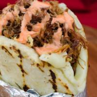 Arepa Rellena · Arepa, stuffed with shredded beef, pork rind, cheese and pink sauce.
