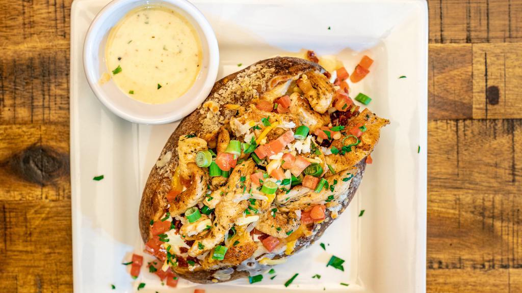 Loaded Baked Potato · With choice of chicken or shrimp, butter, sour cream, bacon, red onions, chives, tomatoes, and queso cheese sauce.