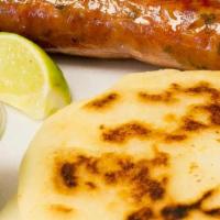 Chorizo, Arepa Y Guacamole · Big sausage, white cheese corn arepa and guacamole.