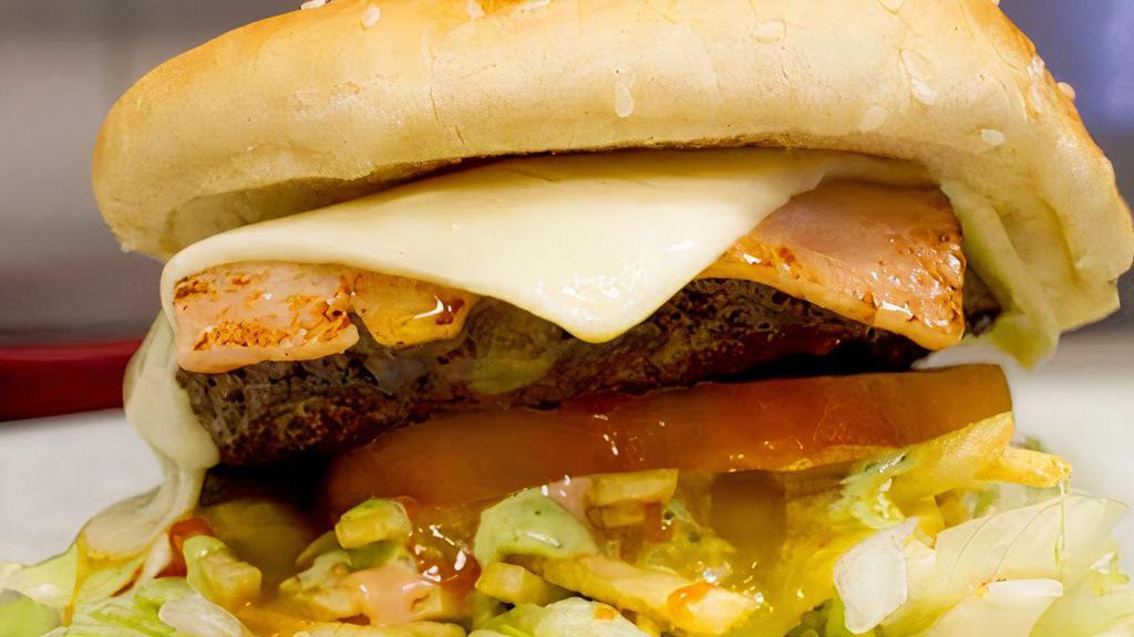 Burger Hawaiiana + Fries · Beef burger, ham and pineapple sauce and fries.