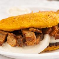 Cachapa Con Chicharron · Corn sweet cake with Guayanes cheese and fried pork belly.