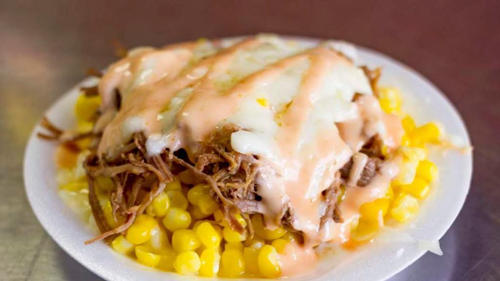 Maicito De Carne · Corn and shredded beef. Sweet grated corn kernels. Includes mozzarella cheese, pink sauce and crushed potato chips.