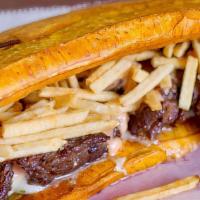 Patacon Carne Asada · Green plantain, grill beef, cheese, homemade sauce and potato sticks. Fried green plantain.