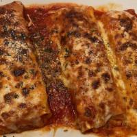 Manicotti · Comes with a soup or salad garlic rolls and baked mozzarella cheese on top.