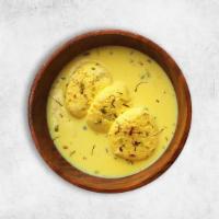 Rasmalai · Soft cheese patties soaked in milk, cardamom and rose water syrup.