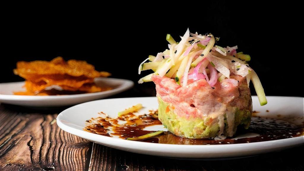 Ahi Tuna Stack · Zesty ahi tuna served atop cucumber and guacamole, topped with jicama slaw & soy ginger sauce. Served with wonton crisps