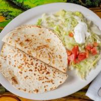 Quesadillas · Pan-seared flour tortilla folded with filled with cheese and onions, chicken, shredded beef,...