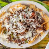 Fajita Nachos · Chicken or steak sizzling fajitas served on a bed of crispy ships with grilled veggies and c...
