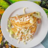 Crispy Tacos · Three crispy tacos stuffed with your choice of beef or chicken and topped with lettuce, toma...