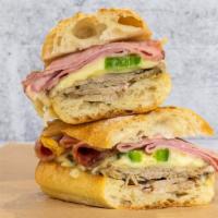Cuban · Black forest ham, roasted pork, Swiss cheese, jalapenos, mojo sauce, French baguette.